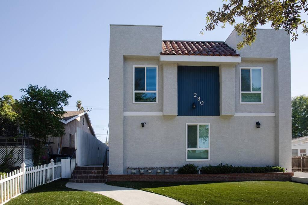 a white house with a fence and a yard at 2BD/2BA Apartment in DT ALhambra in Alhambra