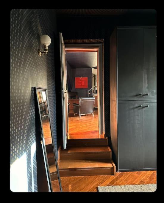 a hallway with a staircase leading to a living room at Mansarda Centro storico Caprilla Guest Flat in Terni