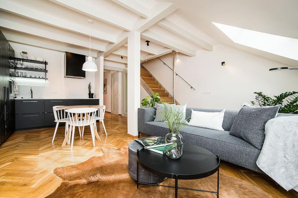 a living room with a couch and a table at Luxurious two-bedroom in the Old Town in Prague