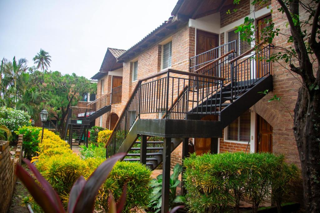 a brick building with a staircase in front of it at VÉLEZ Beach Hotel in San Juan del Sur