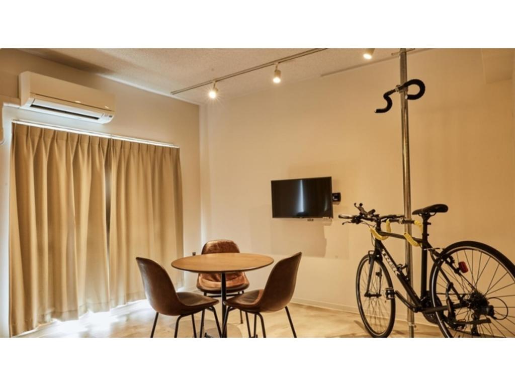 a bike parked in a room with a table and chairs at River Side Arashiyama - Vacation STAY 86248v in Kyoto