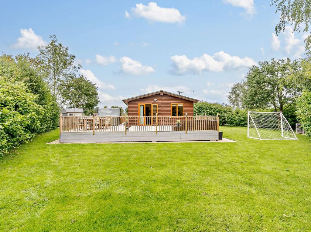a small cabin on a deck with a soccer ball at 3 Bed in York 93206 in Elvington
