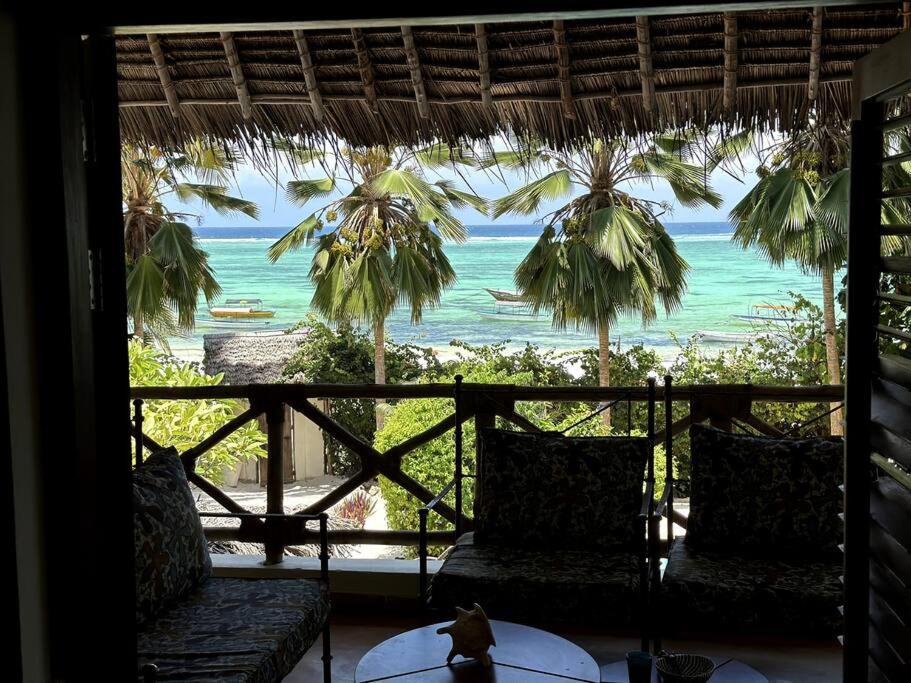 a room with a view of the ocean from a resort at Villa Maua Exclusive in Matemwe