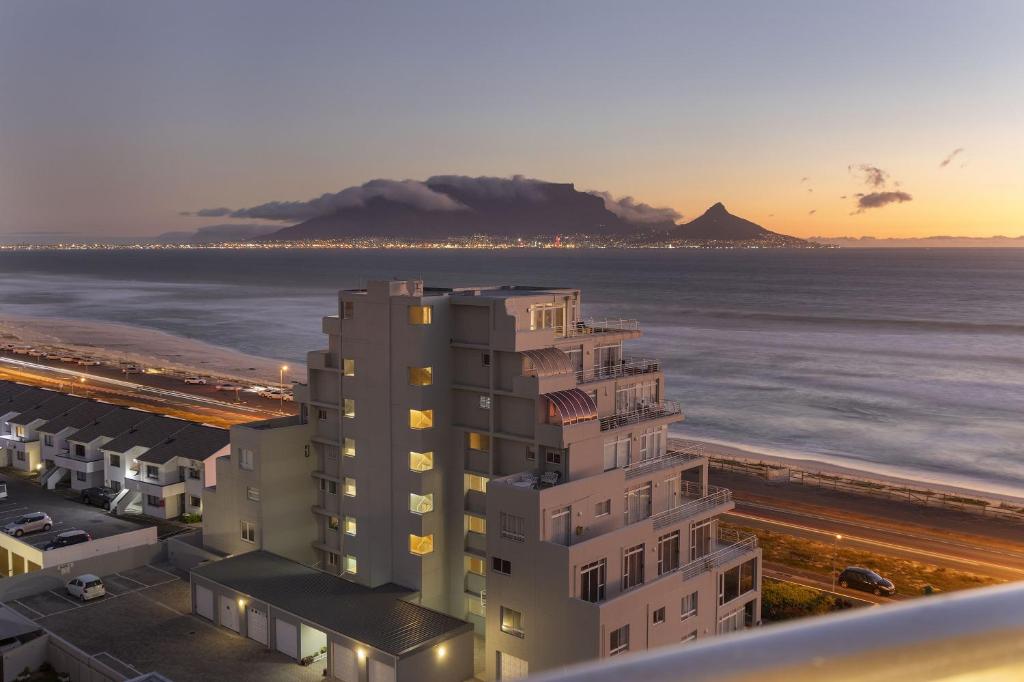 a view of the ocean and a building at Ocean View B901 in Bloubergstrand