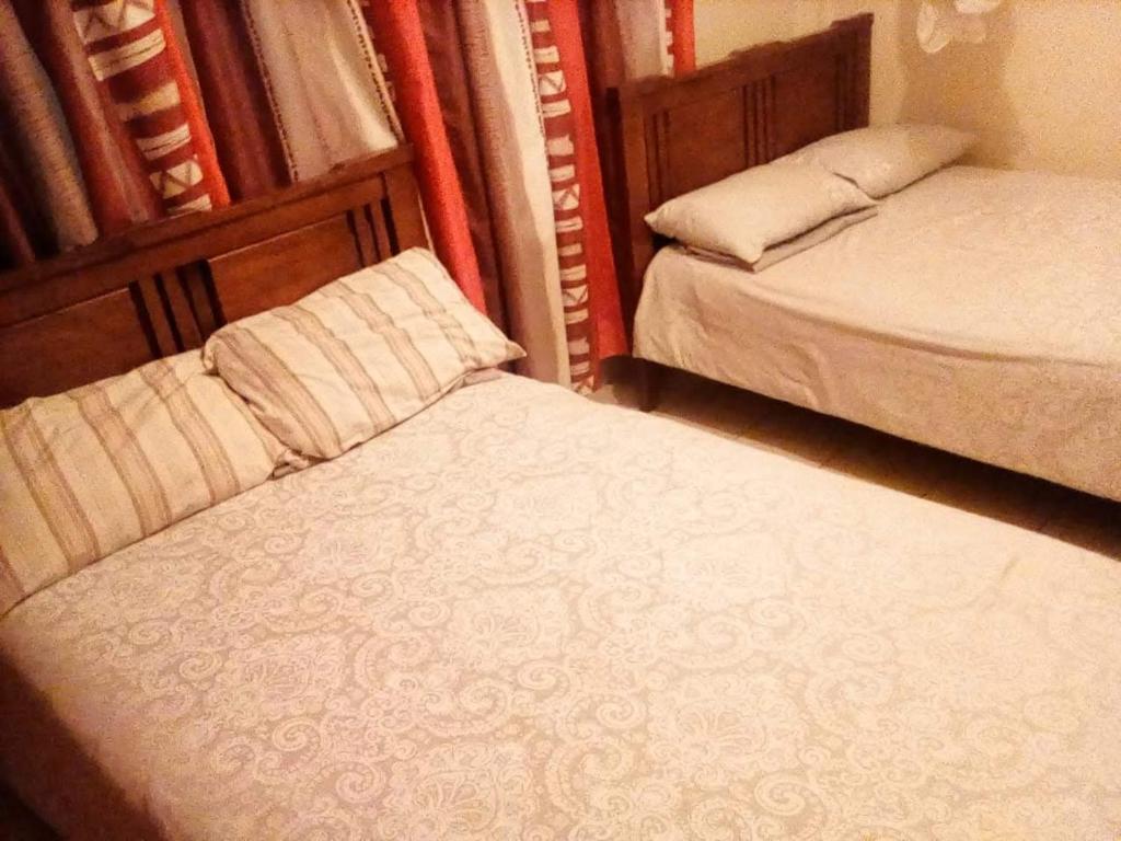 two beds in a small room with at One bedroom panthehouse in Kisumu