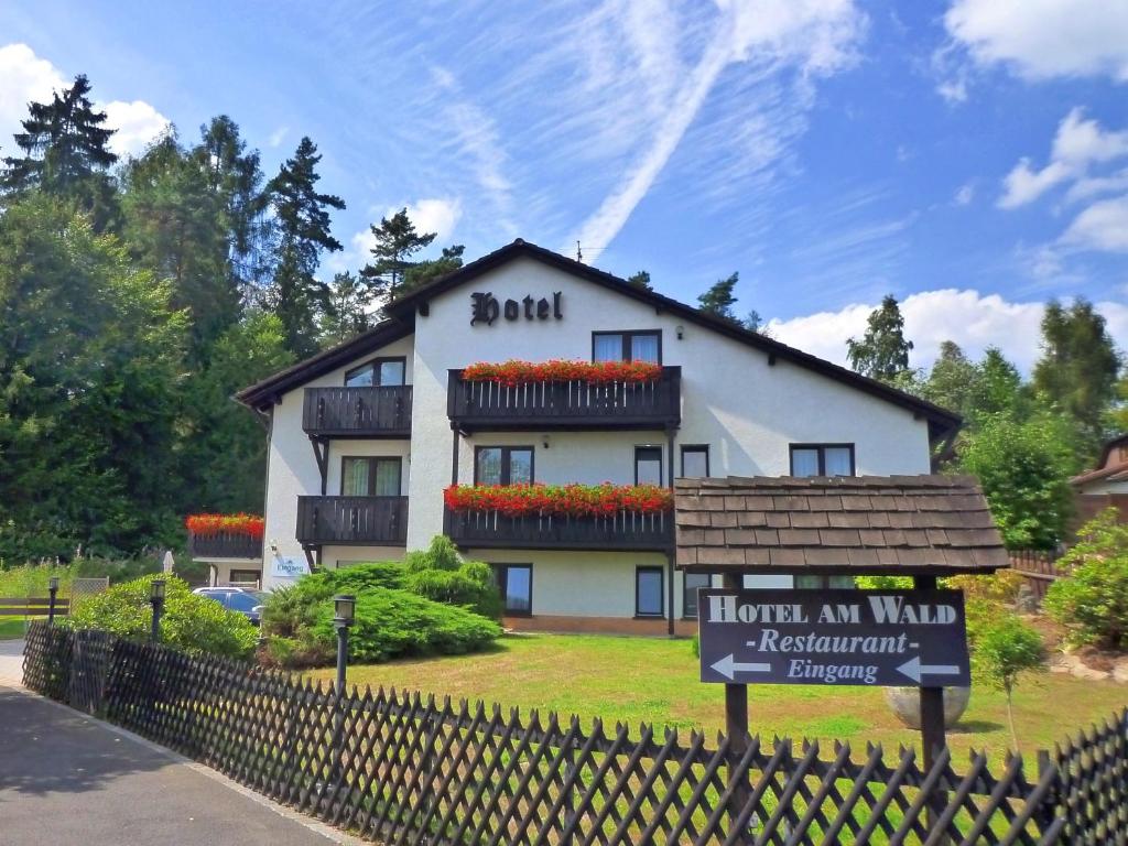 a building with a sign in front of it at Meister BÄR HOTEL Am Wald in Marktredwitz