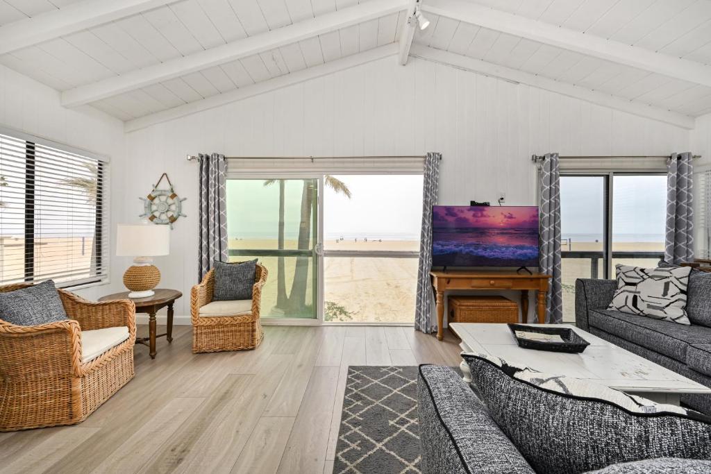 a living room with a view of the beach at Multi Level Oceanfront Home With Oceanviews and Private Patio on the Boardwalk in Newport Beach