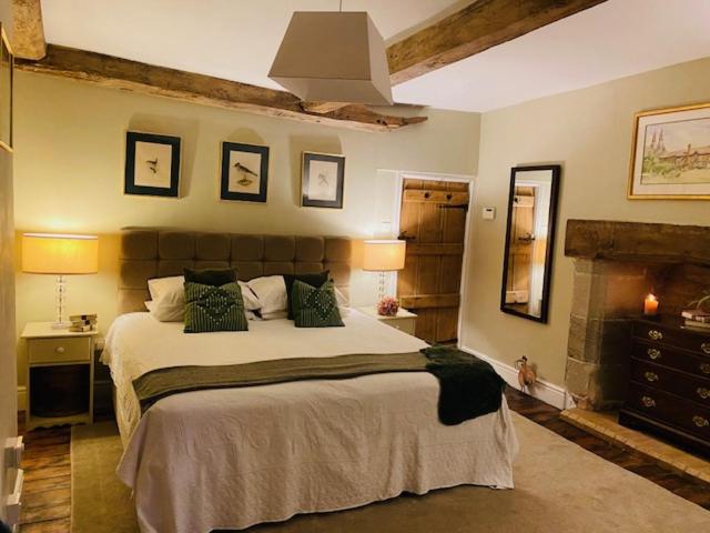 a bedroom with a large bed in a room at White House Farm 