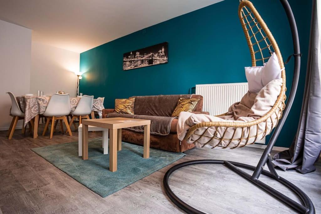 a living room with a couch and a table at *Cosy Home 20' Paris 25' Disney - Free WIFI* in Villiers-sur-Marne