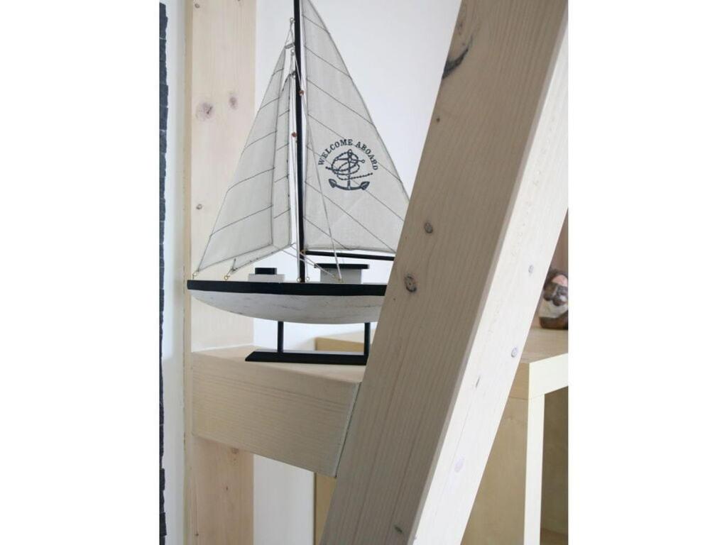 a sail boat on a shelf in a room at Strandhus Sellin - House 1 in Ostseebad Sellin