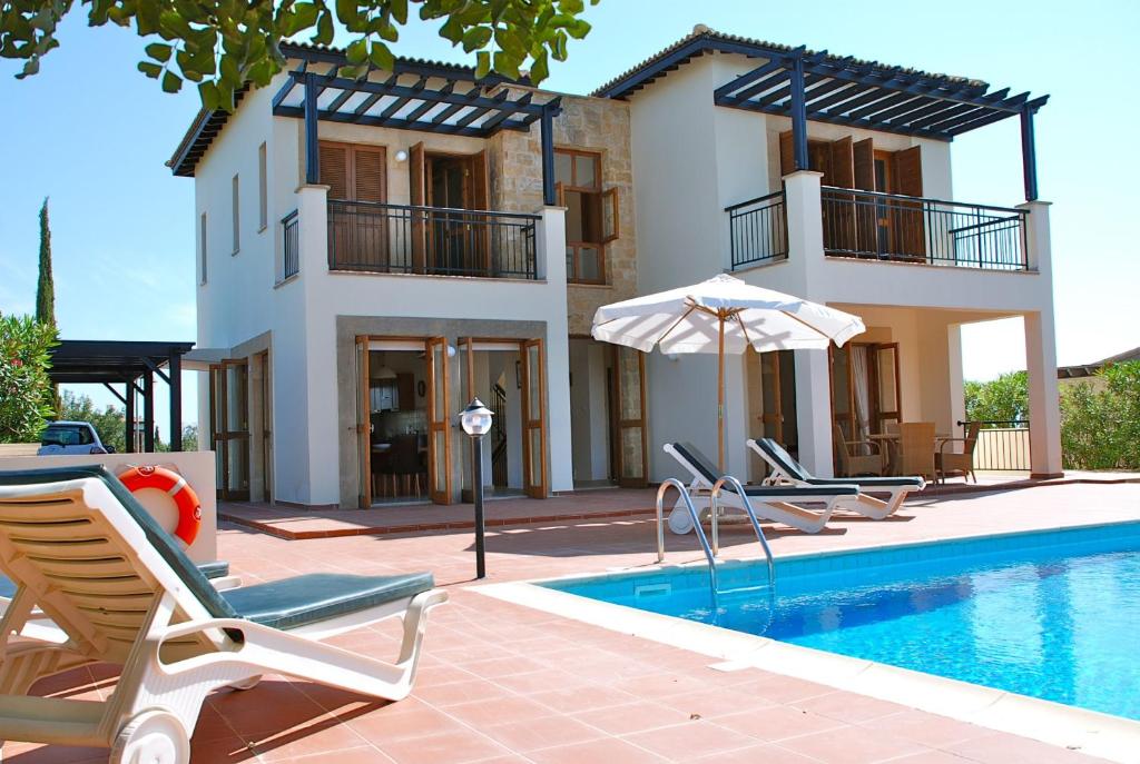 eine Villa mit einem Pool und einem Haus in der Unterkunft 2 bedroom Villa Oleander with private pool and garden, Aphrodite Hills Resort in Kouklia