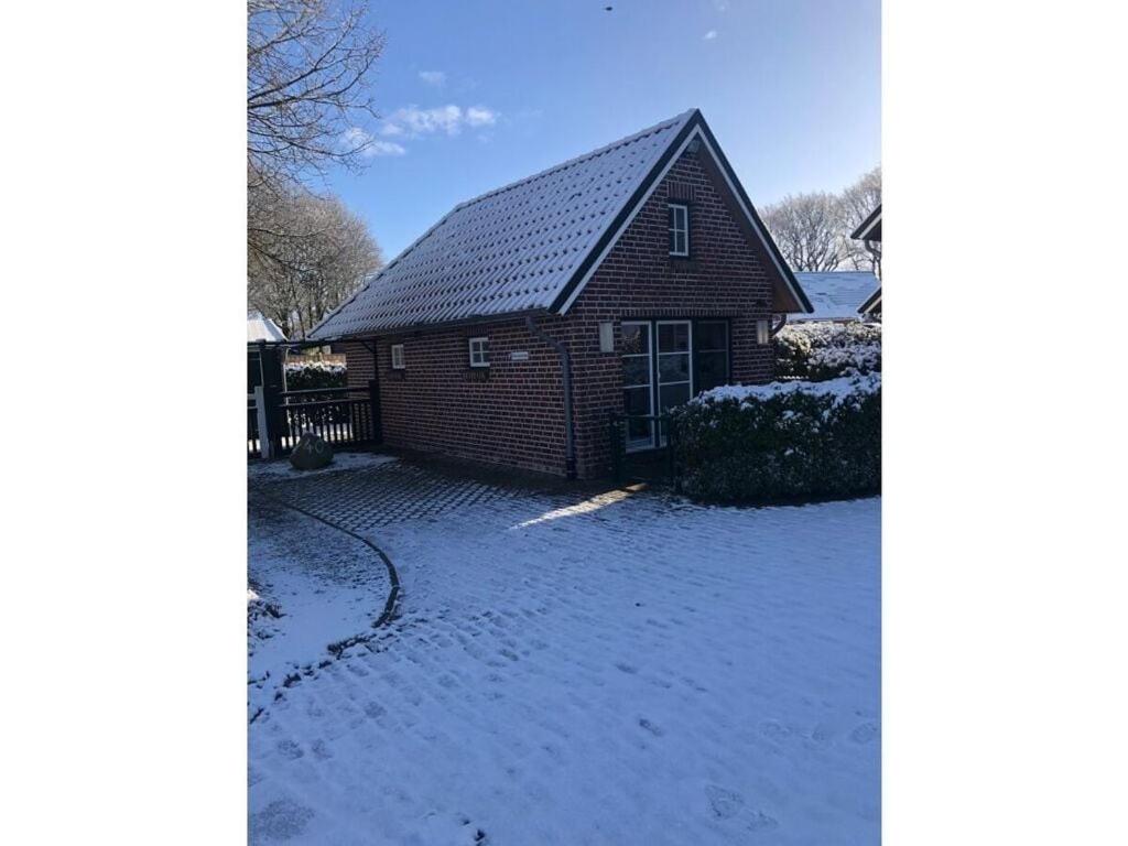 a house with snow on the ground in front of it at Holiday home Feike Comfortable Vacation Home in Zetel