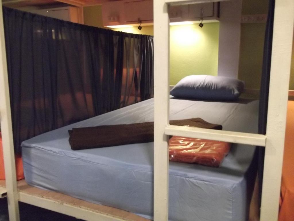 two bunk beds in a room with a mirror at Sleep Tight Hostel at Koh Phangan in Haad Rin