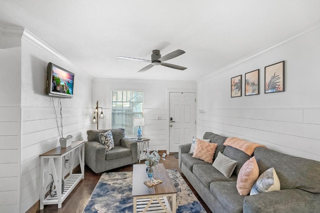 a living room with a couch and a ceiling fan at Anastasia Island Condo in St. Augustine