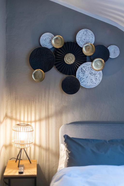 a bedroom with a wall with plates on the wall at 20 seconds to Charles Bridge in Prague