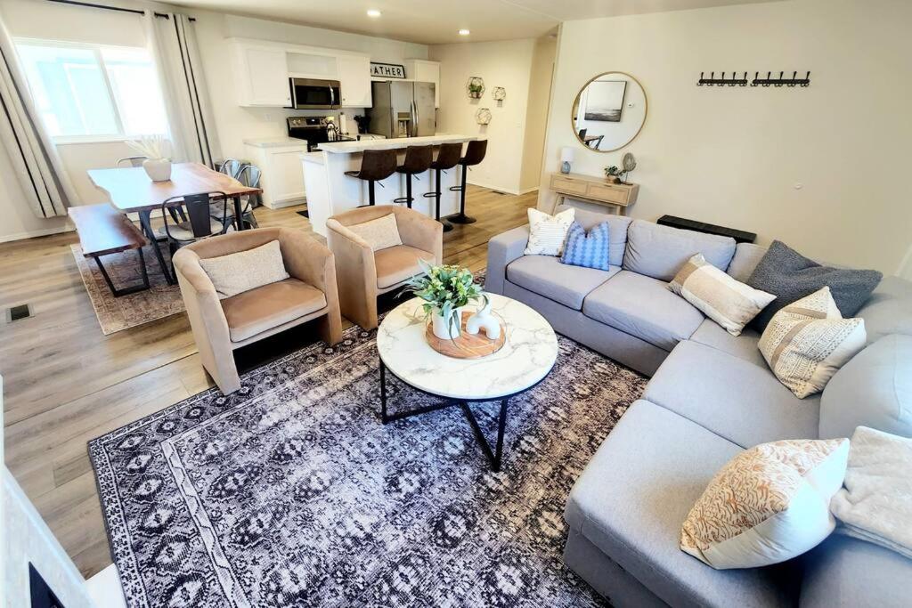 a living room with a couch and a table at The perfect get away home in Garden City