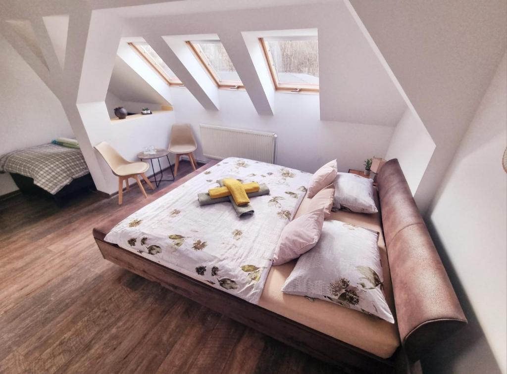 a bedroom with a bed with a banana on it at Penzion ORION in Petrovice