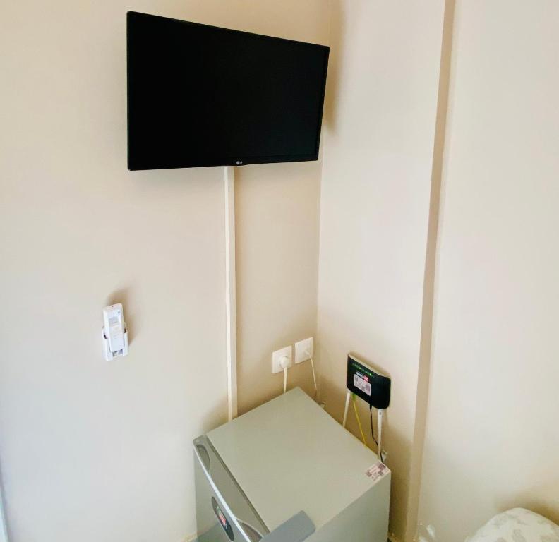 a room with a tv hanging on the wall at Elegant Studio in the center of city. in Thessaloniki