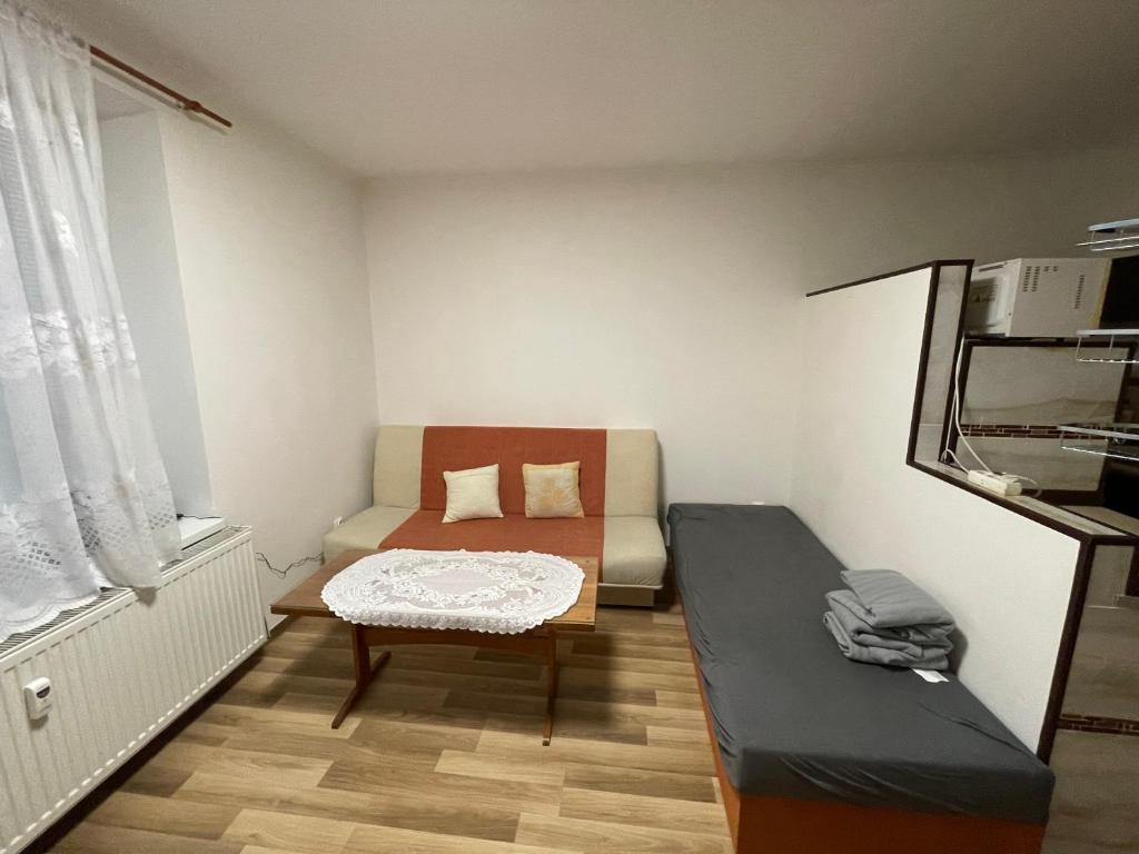 a small room with a couch and a table at Hidden Gem in Košice