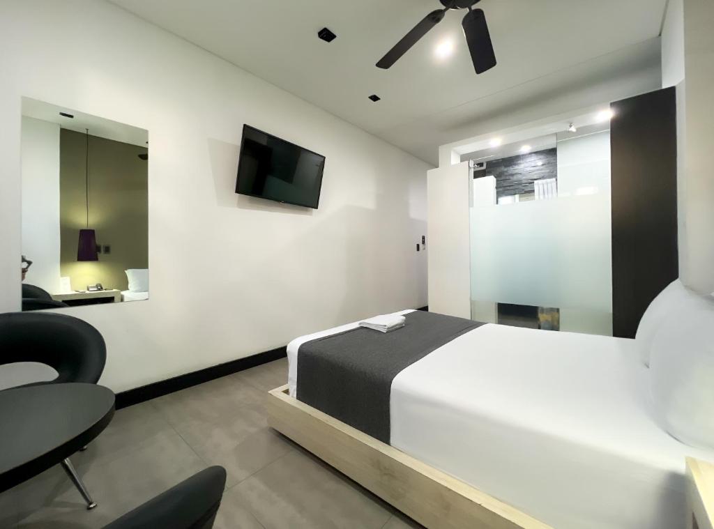 Postel nebo postele na pokoji v ubytování Hotel 47 Medellin Center