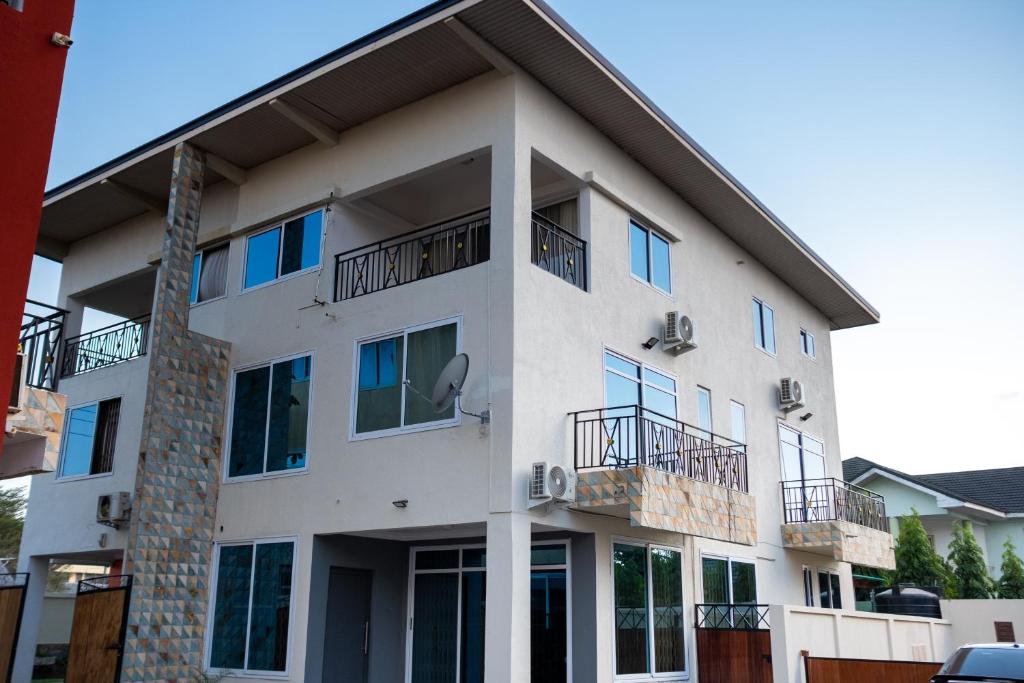 a white building with windows and balconies on it at Shalom Villas in Mamobi