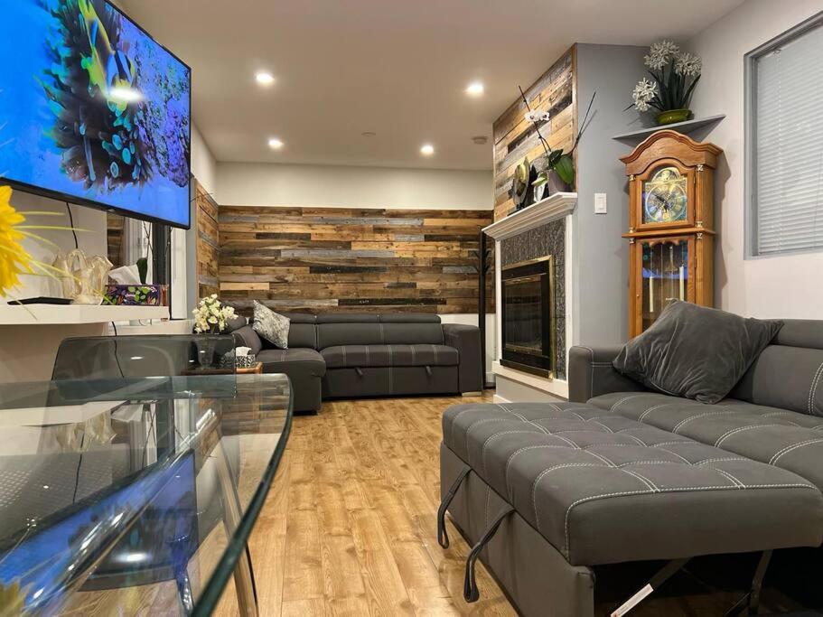 a living room with a couch and a fireplace at Westview Vacation Rental - Two BR House in North Vancouver