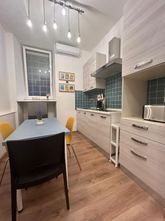 a kitchen with a table and chairs in a room at Step by Rome apt in Rome