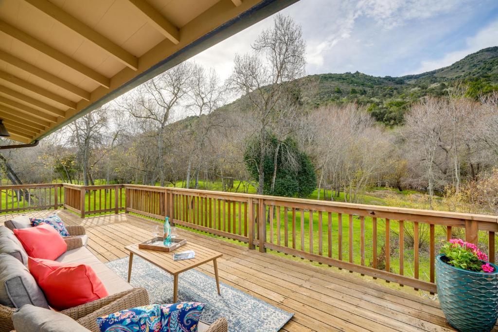 a patio with a couch and a table on a deck at Scenic Carmel Valley Home with Deck Steps to River! in Carmel Valley