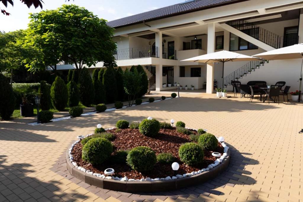 a circular garden in front of a building at ANCA in Saturn