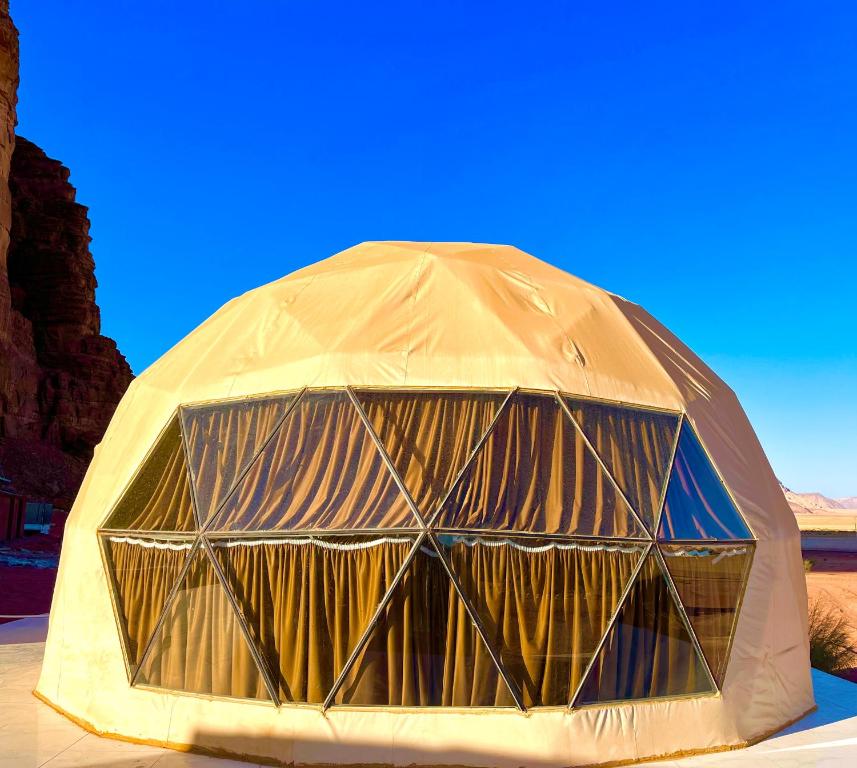 a large dome tent sitting in the desert at Bacific camp in Wadi Rum