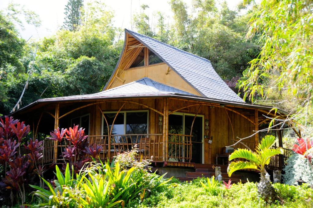 a small wooden house with a gambrel roof at Maui Eco Retreat in Huelo