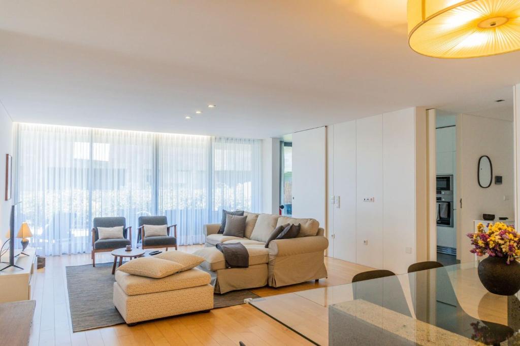a living room with a couch and a table at Beach & Garden Apartment in Ponta Delgada