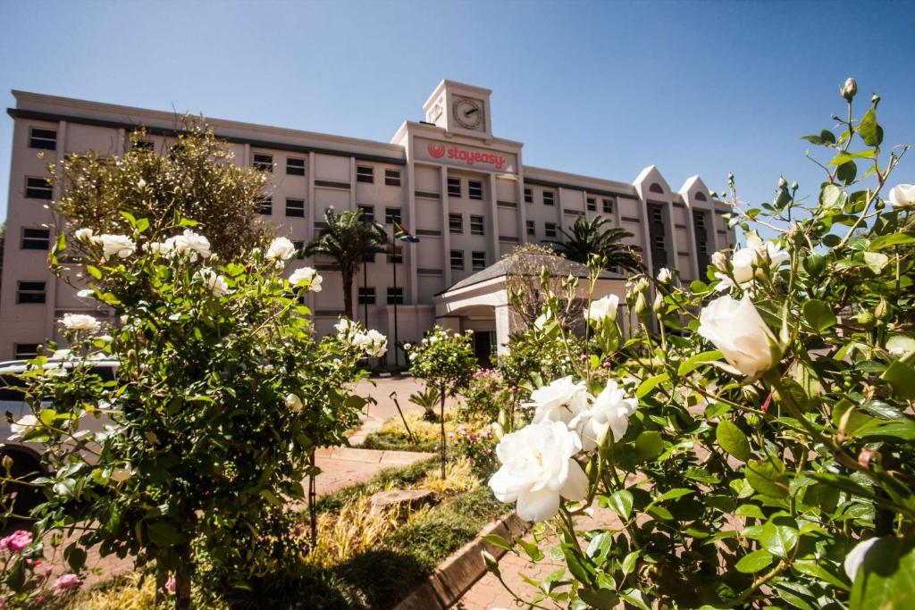 a building with white flowers in front of it at StayEasy Eastgate in Johannesburg