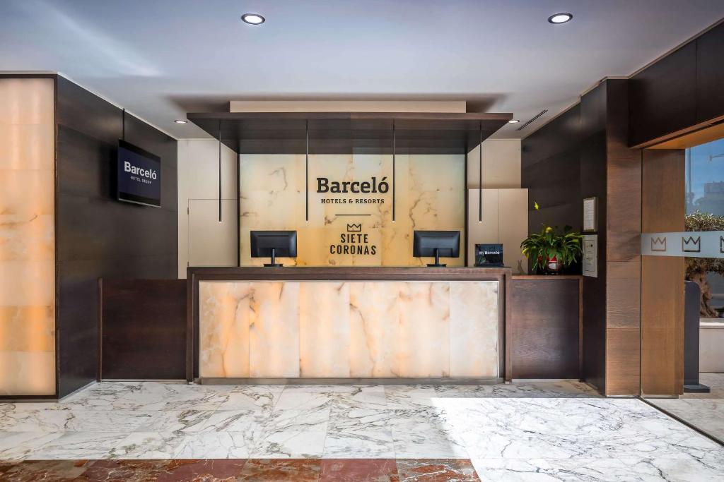 a bar in a lobby with a sign on the wall at Barceló Murcia Siete Coronas in Murcia