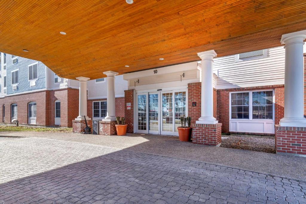 a house with a porch with a wooden roof at Comfort Inn & Suites Dover-Portsmouth in Dover