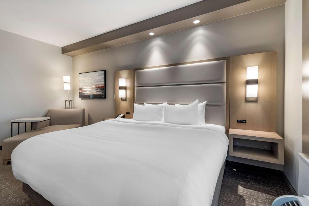 a large white bed in a hotel room at Best Western Premier Prince Albert in Prince Albert