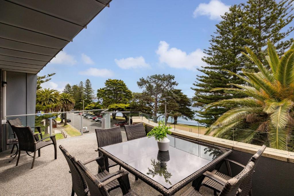 a patio with a table and chairs on a balcony at Beachfront on the Esplanade in Cowes