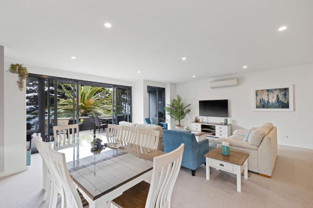 a living room with a couch and a table at Beachfront on the Esplanade in Cowes