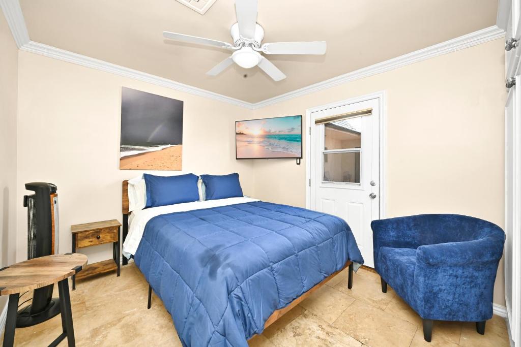 a bedroom with a blue bed and a ceiling fan at 514 E Oceanfront B in Newport Beach