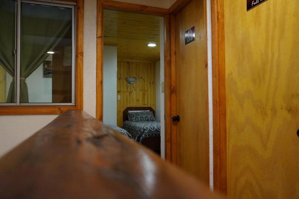 a kitchen with a counter and a door to a room at Residencial del Maule in Linares
