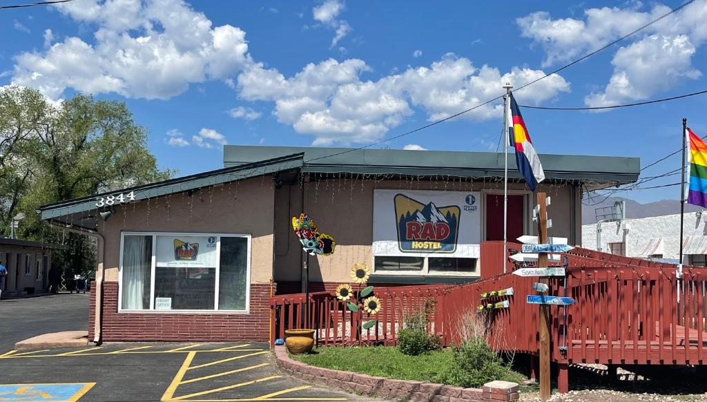 a building with a flag and a rainbow flag at RAD Hostel in Colorado Springs