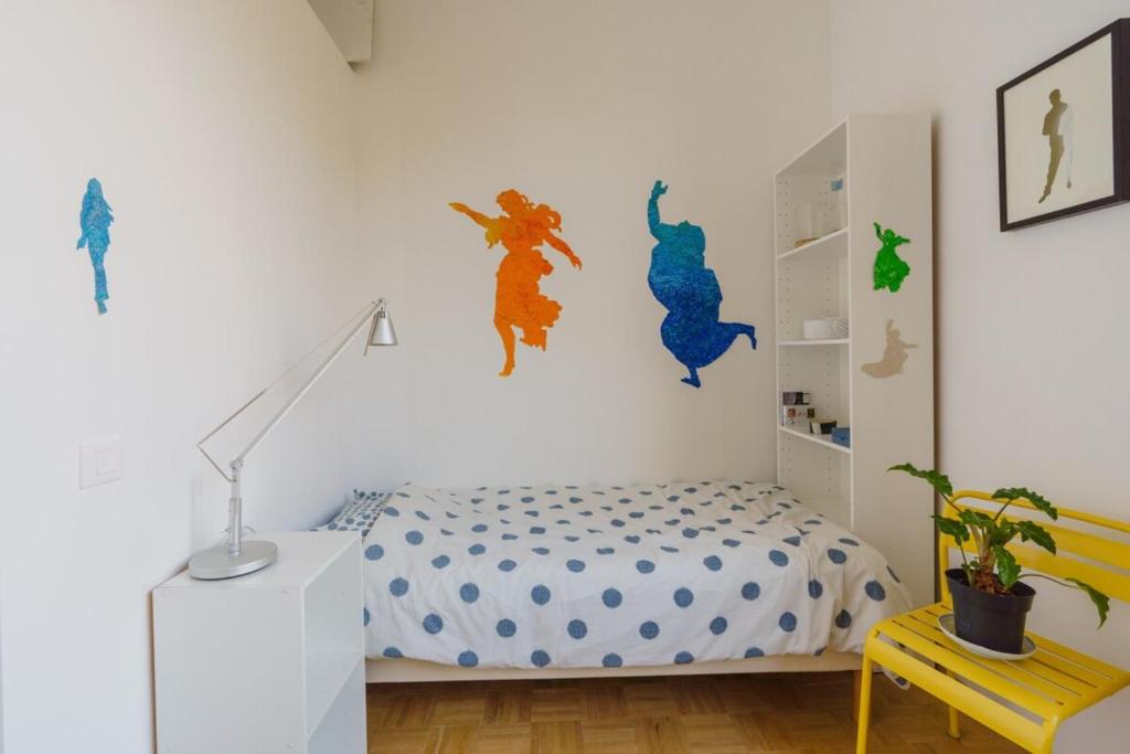 a bedroom with a bed and a wall with dinosaur decals at Centrally-located Studio Reuilly-Diderot in Paris
