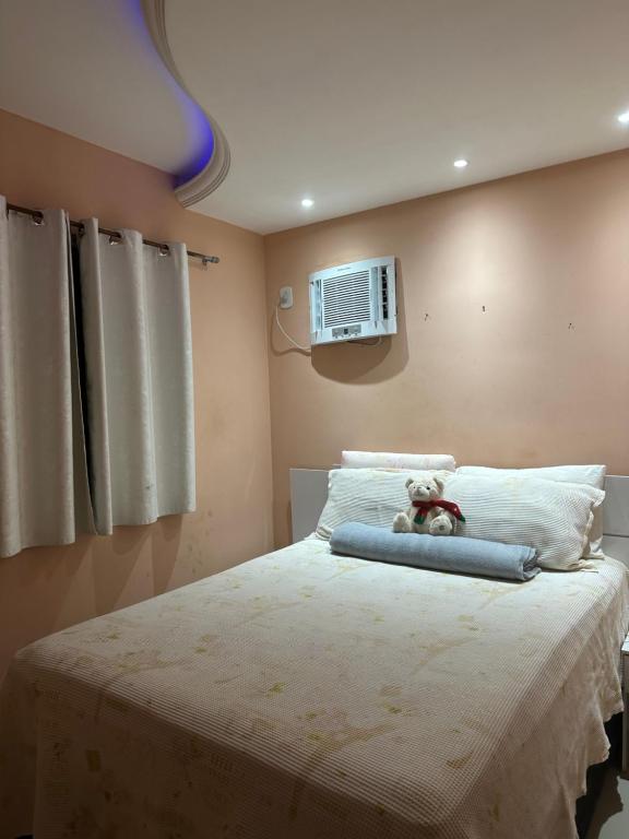 a bedroom with a bed with a teddy bear on it at Apartamento centro de Paulista-Pe in Paulista