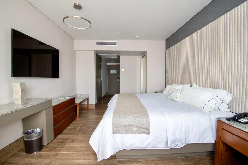 Postel nebo postele na pokoji v ubytování Hotel Plaza Diana