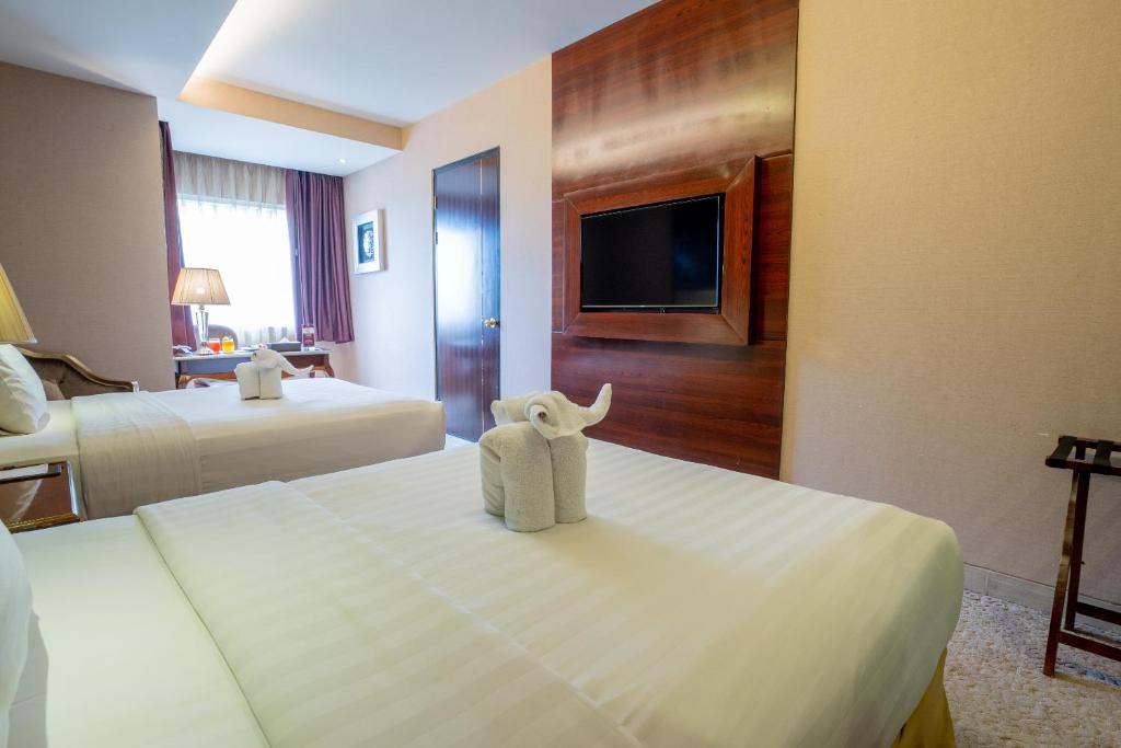 Postel nebo postele na pokoji v ubytování Belviu Hotel Bandung