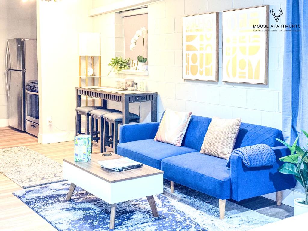 a blue couch in a living room with a coffee table at The Moose #12 - Brand New Modern Luxe Loft with Free Parking, King Bed & Fast WiFi in Memphis
