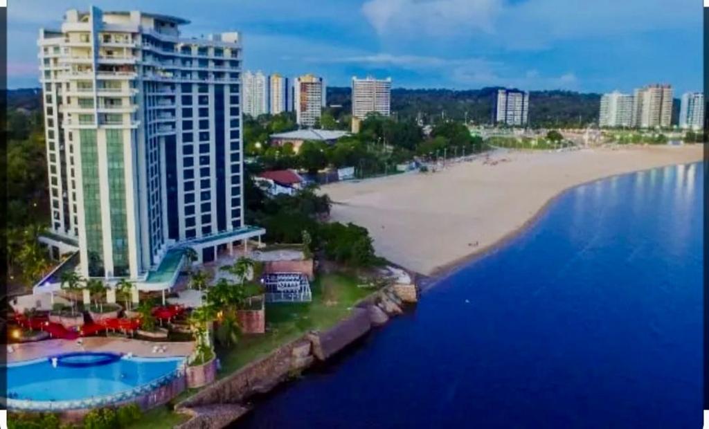 an aerial view of a beach and a building at Tropical Executive Hotel APT 606 in Manaus