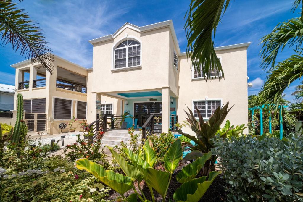 a house on the beach with palm trees at Hidden Gem Barbados in Christ Church