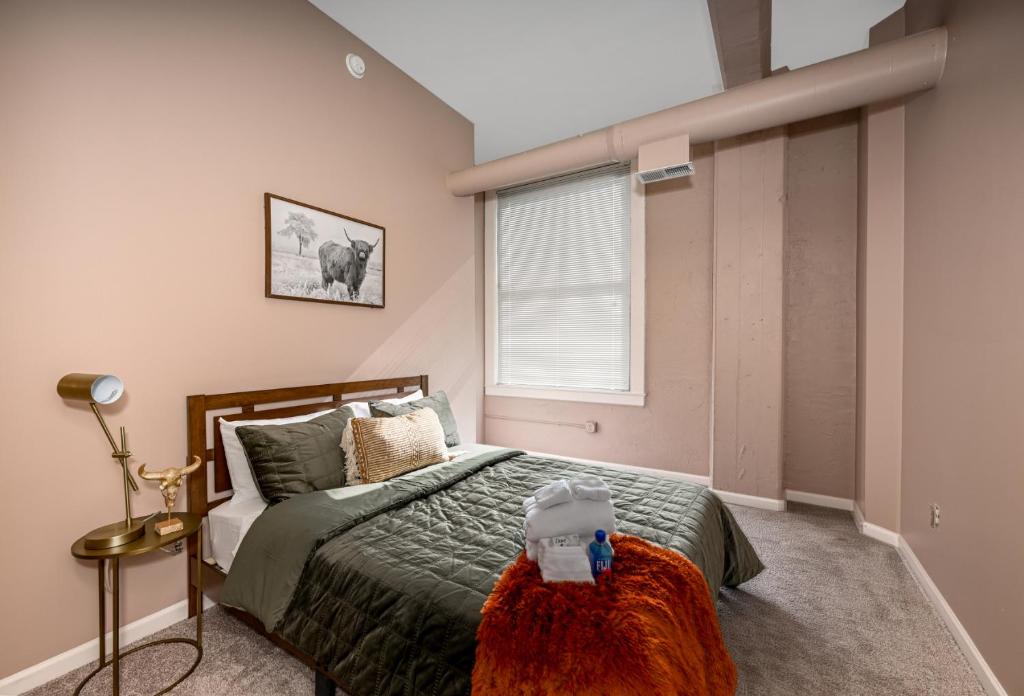 a bedroom with a bed and a window at 2 bath Prkg+Gym+Sauna Perk Plaza +30 Day in Cleveland