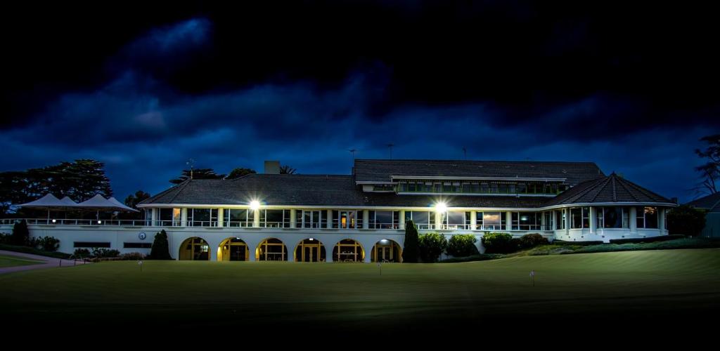 a large building on a golf course at night at The Victoria Golf Club in Melbourne
